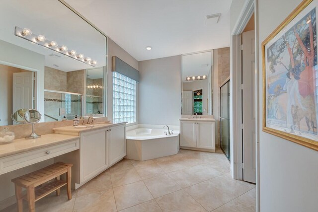 bathroom featuring vanity, independent shower and bath, and tile patterned floors