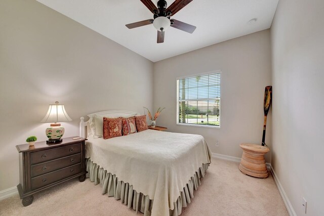 bedroom with ceiling fan and light carpet