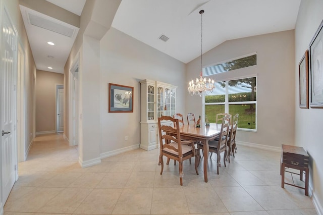 tiled dining space with lofted ceiling and an inviting chandelier