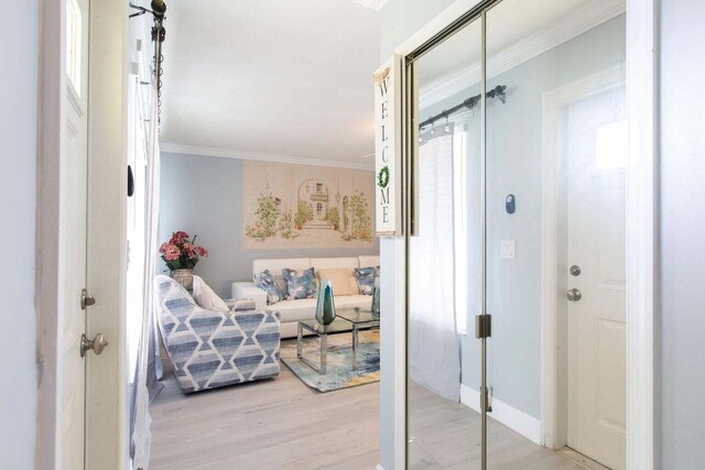 interior space featuring ornamental molding and light hardwood / wood-style flooring