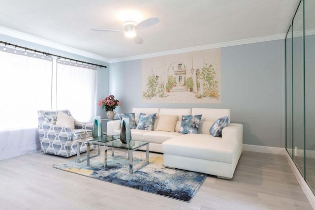 living room featuring light hardwood / wood-style flooring, ceiling fan, and ornamental molding