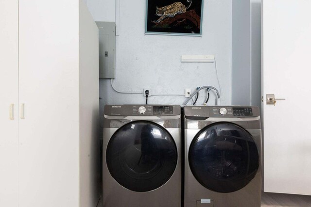 washroom featuring electric panel and washing machine and dryer