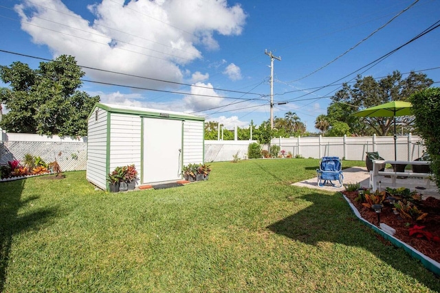 view of yard with a storage unit and a patio