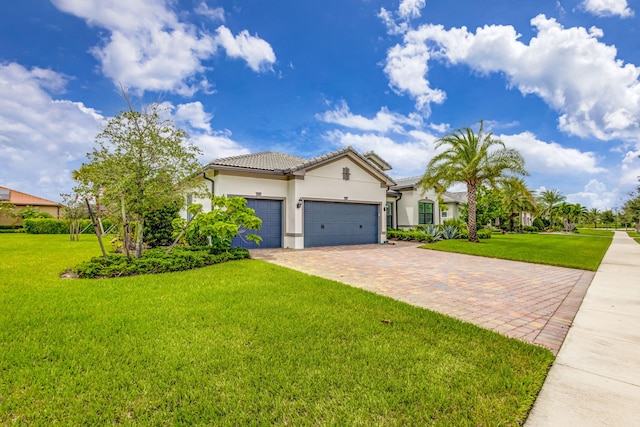 mediterranean / spanish-style home featuring a garage and a front yard