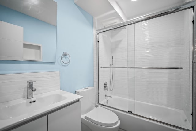 full bathroom with vanity, toilet, and combined bath / shower with glass door