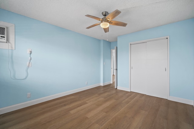 unfurnished bedroom with a textured ceiling, hardwood / wood-style floors, and ceiling fan