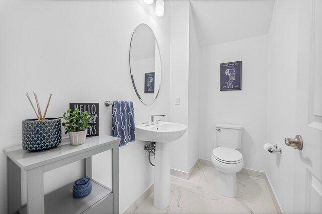 bathroom with toilet and tile patterned floors