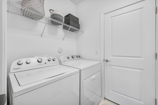 clothes washing area with washing machine and clothes dryer