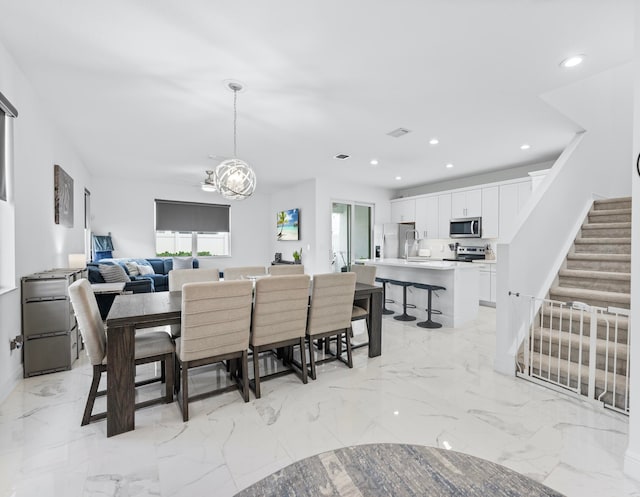 tiled dining room featuring an inviting chandelier