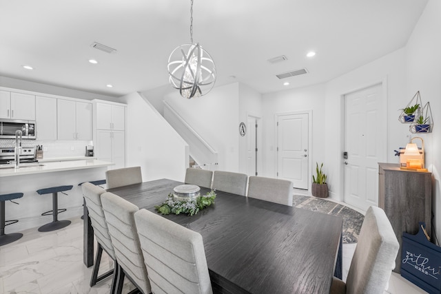 dining room featuring an inviting chandelier and light tile patterned floors