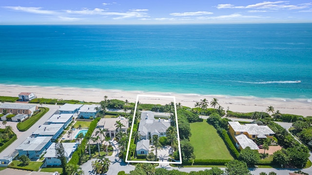 drone / aerial view with a water view and a beach view