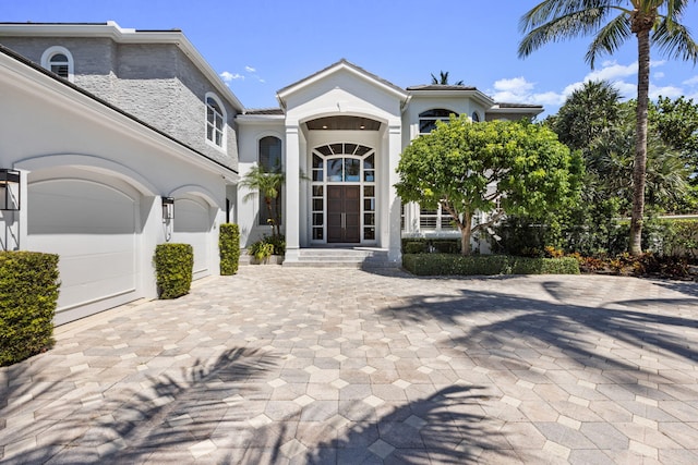 view of exterior entry with stucco siding