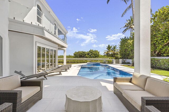 view of swimming pool with an outdoor living space and a patio area