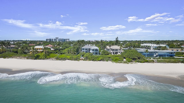 drone / aerial view featuring a view of the beach and a water view