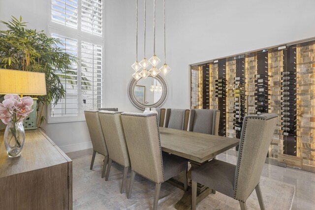 dining room with a towering ceiling and a notable chandelier