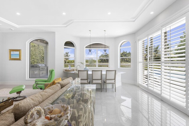 living room featuring a raised ceiling and light tile patterned floors