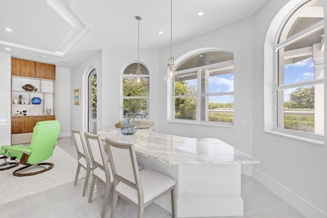 dining space with breakfast area, recessed lighting, light tile patterned flooring, and baseboards