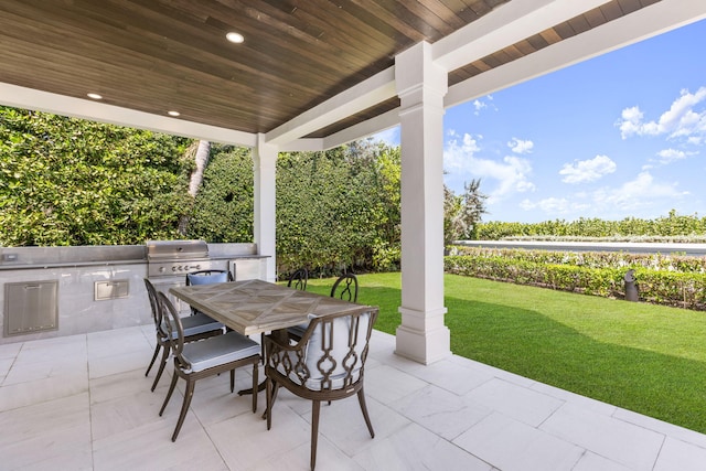 view of patio / terrace featuring outdoor dining area, a grill, and an outdoor kitchen