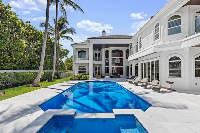 view of pool with a pool with connected hot tub and a patio