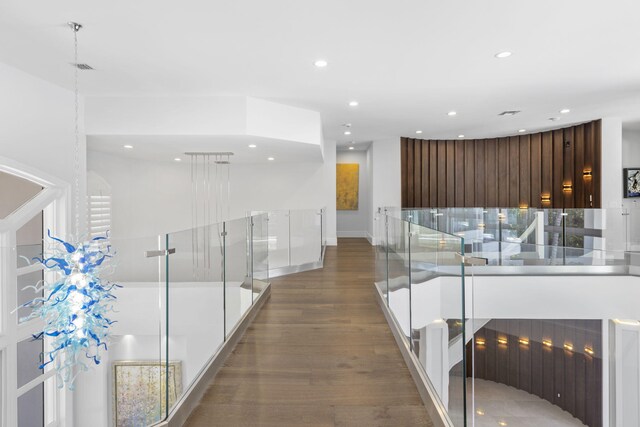 corridor with hardwood / wood-style floors