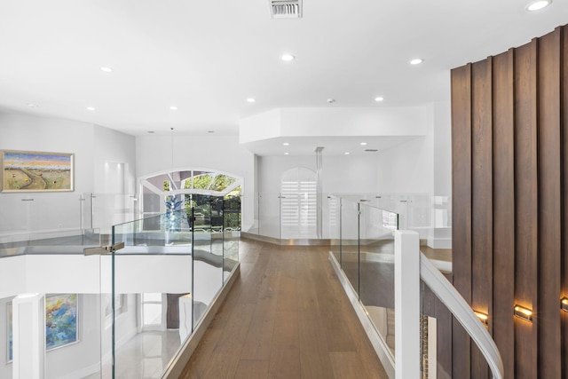 hallway featuring wood finished floors, visible vents, and recessed lighting