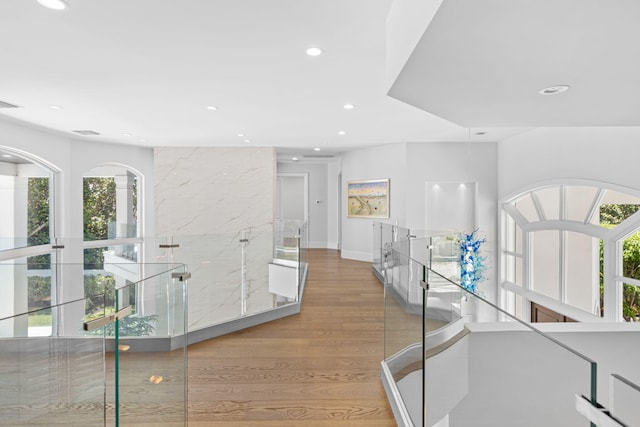 hallway with light hardwood / wood-style floors