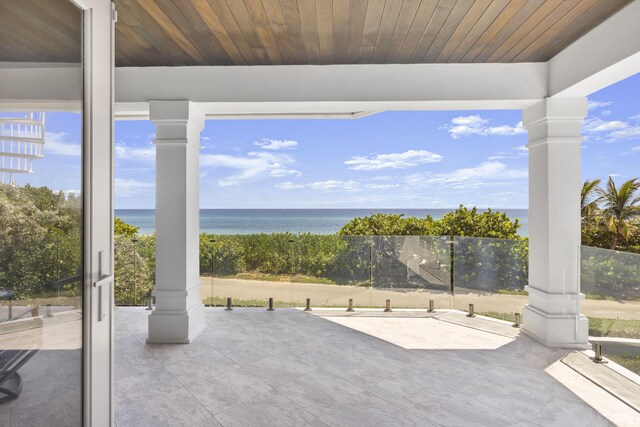 view of patio with a water view