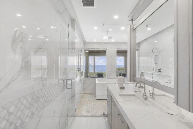 bathroom featuring vanity, a shower, and tile patterned flooring