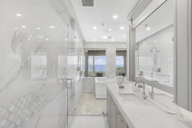 full bathroom with recessed lighting, visible vents, vanity, and a marble finish shower