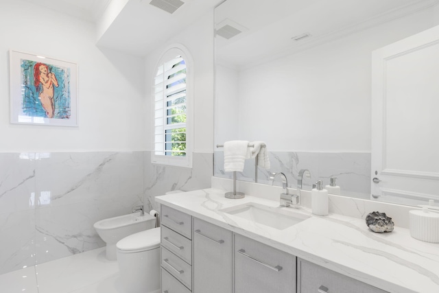 bathroom featuring toilet, vanity, visible vents, tile walls, and a bidet