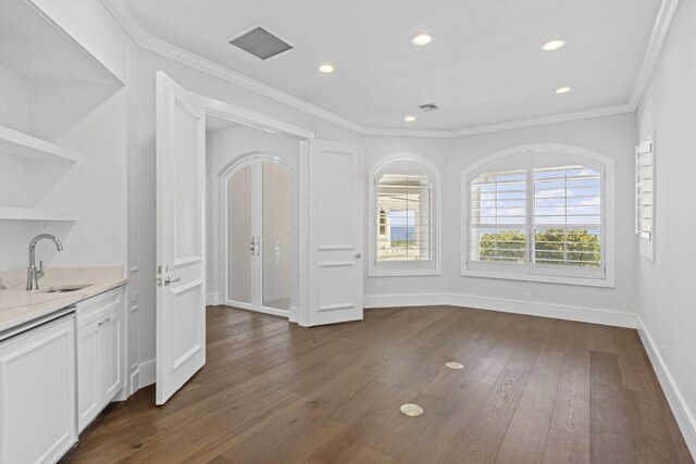 interior space with ornamental molding, sink, and dark hardwood / wood-style floors