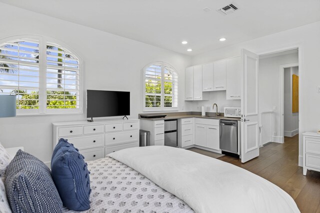 bedroom featuring dark wood-type flooring, stainless steel fridge, and sink