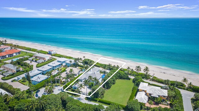 birds eye view of property featuring a view of the beach and a water view