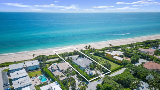 aerial view featuring a view of the beach and a water view