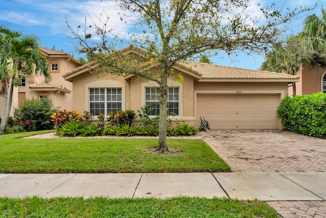 view of front of home featuring a garage and a front lawn