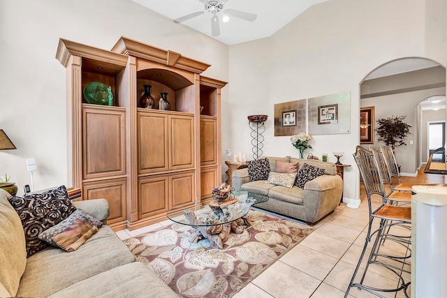 living room with high vaulted ceiling, light tile patterned floors, and ceiling fan