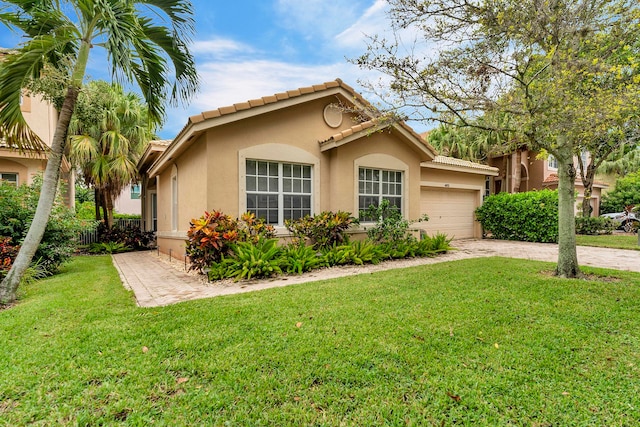 view of front of home with a garage and a front yard