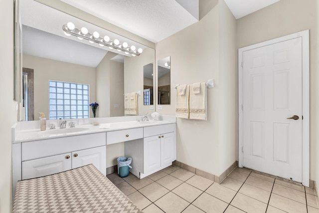 bathroom featuring vanity, a textured ceiling, and tile patterned flooring