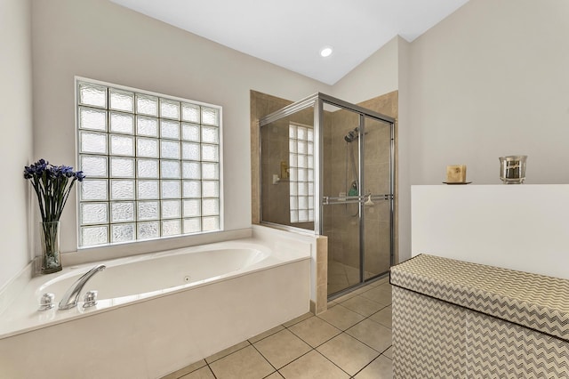 bathroom with a wealth of natural light, tile patterned flooring, and plus walk in shower