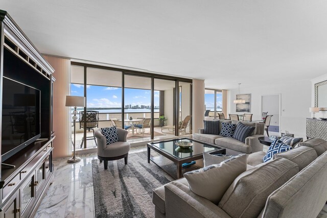 living room with a water view and a wall of windows