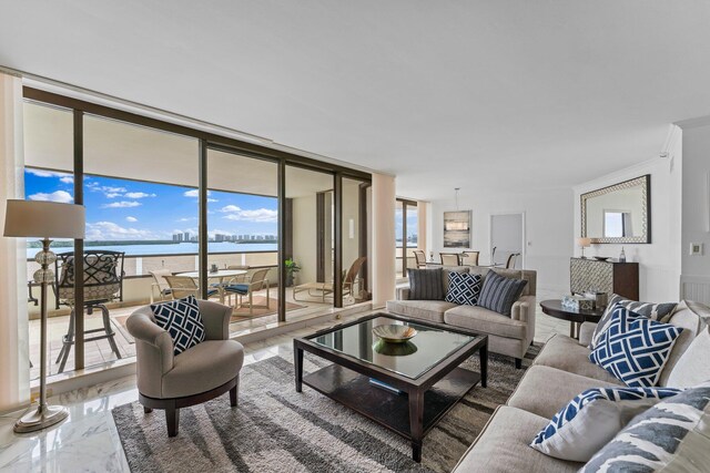 living room with floor to ceiling windows and a water view