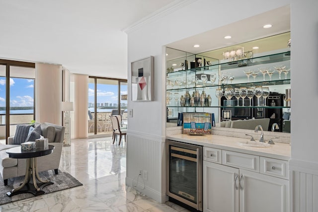 100 Lakeshore Dr Unit 457, North Palm Beach, FL 33408 - indoor wet bar featuring wine cooler, light marble finish floors, a wainscoted wall, crown molding, and a wall of windows