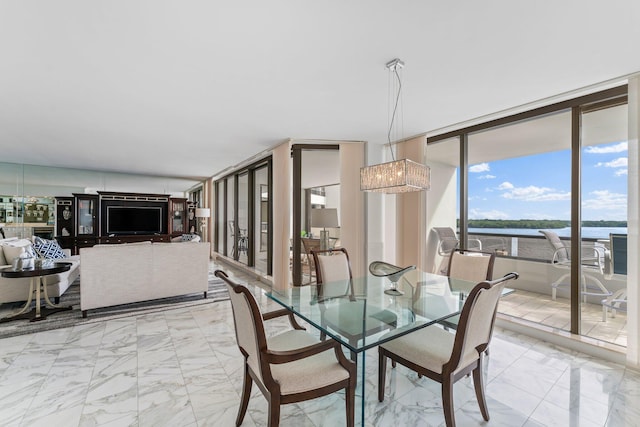 100 Lakeshore Dr Unit 457, North Palm Beach, FL 33408 - dining space with light marble finish flooring, floor to ceiling windows, a water view, and a chandelier