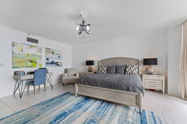 tiled bedroom with ornamental molding and ceiling fan