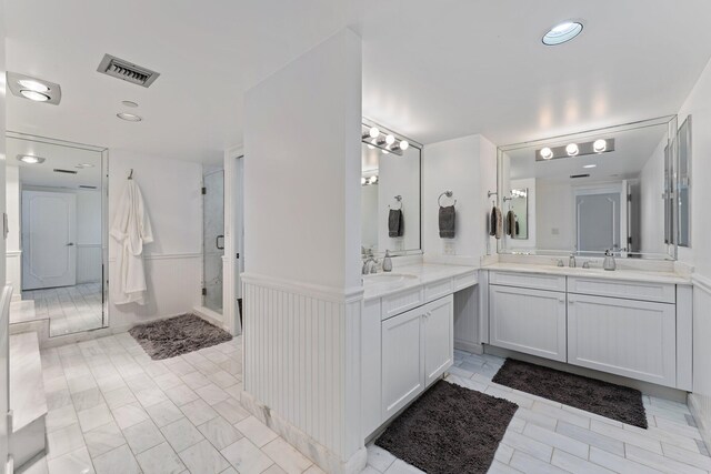100 Lakeshore Dr Unit 457, North Palm Beach, FL 33408 - full bathroom featuring a shower stall, two vanities, a wainscoted wall, and recessed lighting