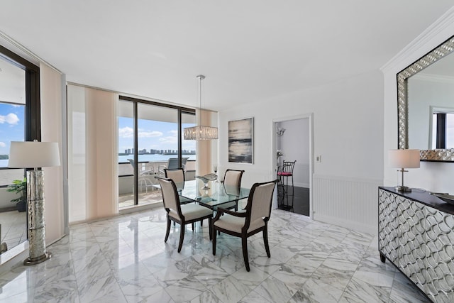 100 Lakeshore Dr Unit 457, North Palm Beach, FL 33408 - dining space featuring ornamental molding, a wainscoted wall, light marble finish flooring, a wall of windows, and a water view