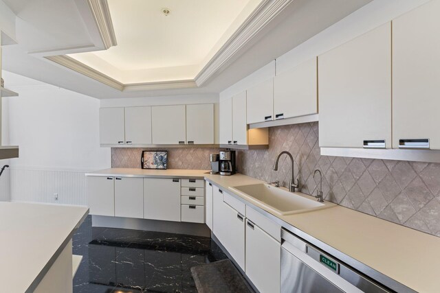 kitchen featuring pendant lighting, tasteful backsplash, white cabinets, a chandelier, and ornamental molding