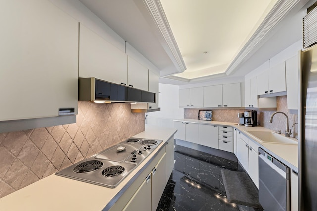 100 Lakeshore Dr Unit 457, North Palm Beach, FL 33408 - kitchen with a sink, appliances with stainless steel finishes, backsplash, a tray ceiling, and white cabinetry