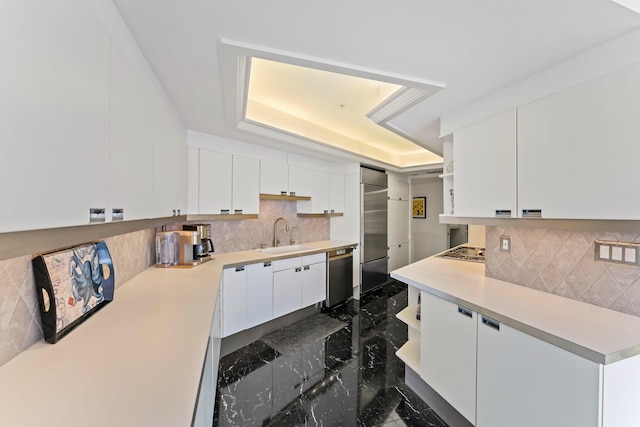 100 Lakeshore Dr Unit 457, North Palm Beach, FL 33408 - kitchen featuring a sink, stainless steel appliances, white cabinetry, light countertops, and backsplash