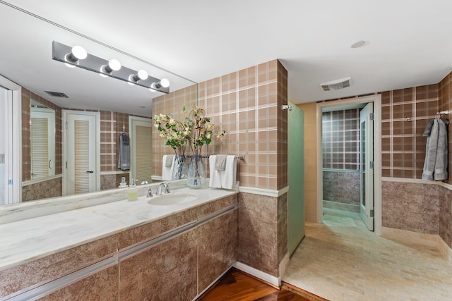 100 Lakeshore Dr Unit 457, North Palm Beach, FL 33408 - bathroom featuring vanity and tile walls